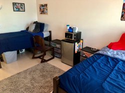 Two beds on either side of a room in a Double Room in the Heights.
