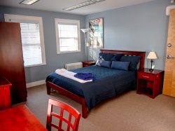 The Blueberry room bed in the Montclair State Guest House.