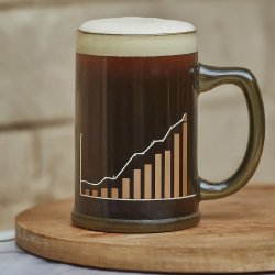 A mug of dark beer with foam on top with a line graph on the mug.