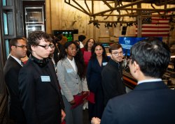 Paola Benavides Pena with other students touring the NYSE