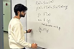 student solving math problem on whiteboard