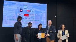 graduate students receiving their best paper