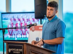 George Alexandris, track star, speaking at the Red Hawk Open