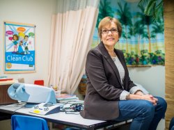 photo of Colette Crescas sitting on a desk