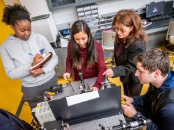 Students and a teacher in a physics lab at Montclair State