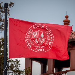 Montclair State University flag outside of Cole Hall.