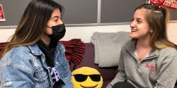 Picture of two students one wearing a mask and the other not.