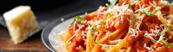 Picture of a plate of pasta with tomato sauce.
