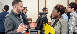 Image of a student speakng with a prospective employer at a career fair.