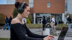 Student on their laptop outside