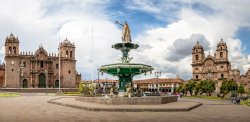 Panoramic view of Plaza de Armas with Inca fountain, Cathedral and Compania de Jesus Church - Cusco, Peru
