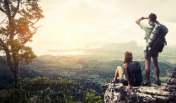 hikers on rock overlooking valley