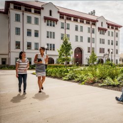 Students walking on campus in front of the Center for Environmental and Life Sciences
