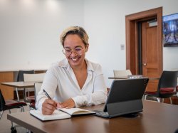 A Bachelor of Arts in Liberal Studies student smiling while working in a virtual advising appointment