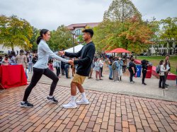 Two students dancing salsa