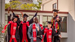 Assistant Provost Daniel Jean and graduating students