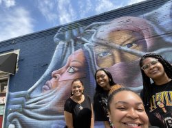 Nadia WIlliams, Lamani Crawford, Tamara Dixon and Dominique Metivier pose in front of a mural