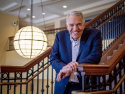 Rob Gilbert smiling on stairs