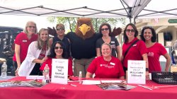 Development staff poses with Rocky at the Red Hawk Open