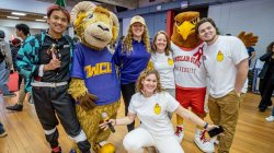 Rocky poses with Montclair staff and students, West Chester University mascot