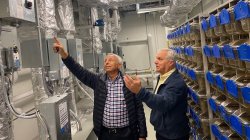 Chris Henry in corridor examining HVAC system