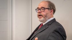 A man gestures as he speaks.