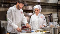 President Koppell in a kitchen with a chef at his side