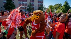 Rocky the Red Hawk celebrating with Montclair State University students