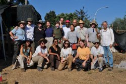 Group of archaeology students posing for photo at dig site