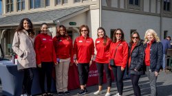 group of attendees pose in front of sign-in table