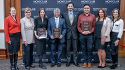 People who won awards pose for a photo with leaders on human trafficking.