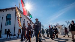 Officers with a US Flag, a NJ state flag, and the Black Liberation flag lead a procession across campus.