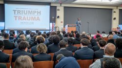 Daniel Jean gives a presentation to an audience about Triumph over Trauma.