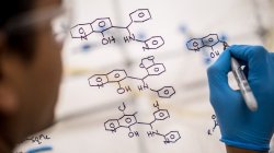 Scientist drawing up a molecular structure.