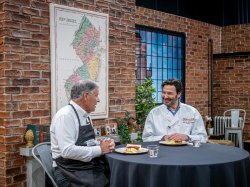 President Koppell talking with candidate Jon Brammick on the set of Cooking with Koppell