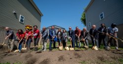 Community leaders and partners shoveling dirt for groundbreaking.