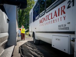 Monica Smith standing near University shuttle.