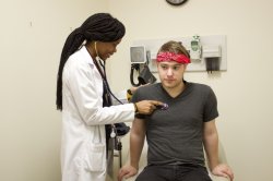 Student getting checked out by a health professional