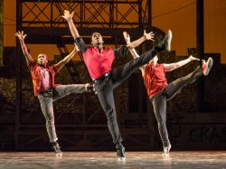 Photo of three student dancers performing in West Side Story play.