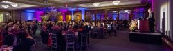 Dinner guests at tables listening to speaker at Annual Scholarship Dinner event.