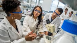 3 students running experiment in laboratory