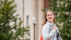Student walking on campus looking over her shoulder