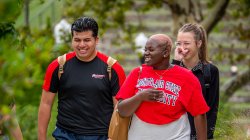 Three students walking and laughing