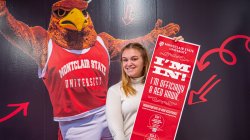 Accepted student holds a poster announcing her acceptance to Montclair State University.