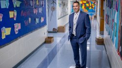Harold Abraham standing in the hallway of an elementary school