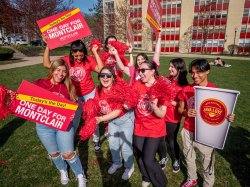Students celebrating One Day Montclair with signs and pompoms.