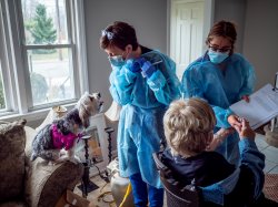 Photo of nursing students delivering the COVID-19 vaccine to a senior in her home