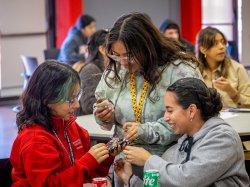 Three students talking and smiling