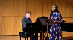 A female student sings while male pianist accompanies.