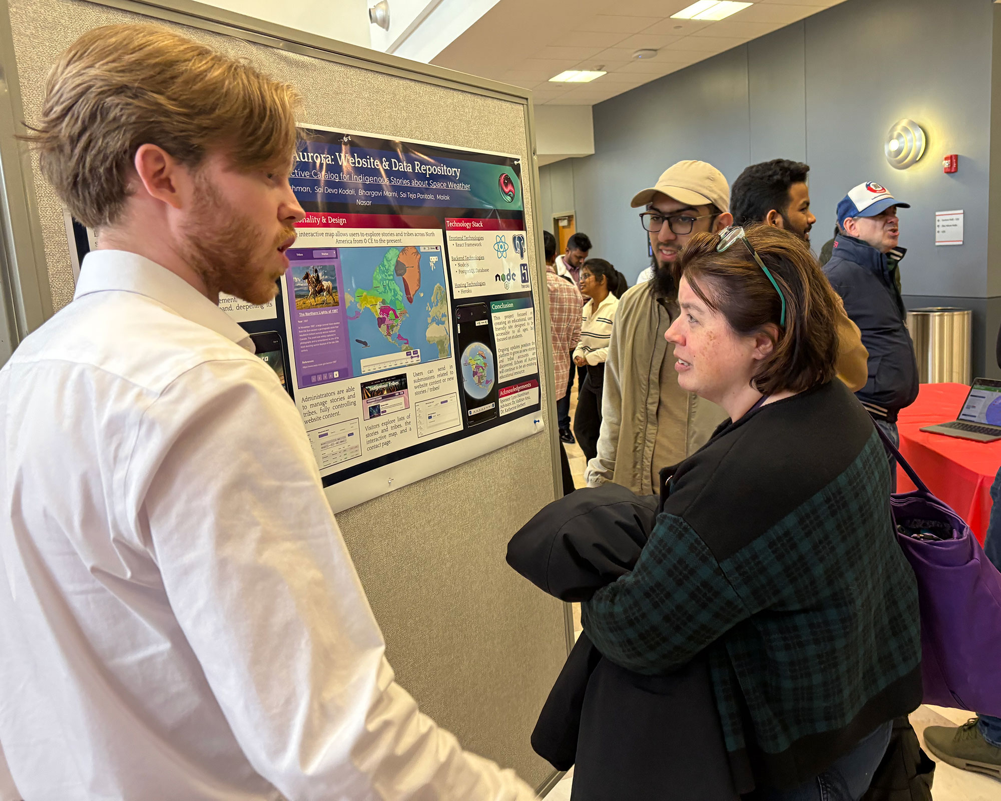 student talking to faculty about Capstone project